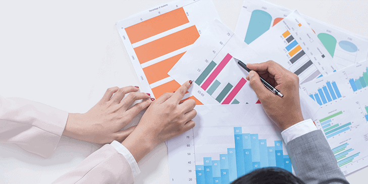 a man and woman showing bar graphs and analytics